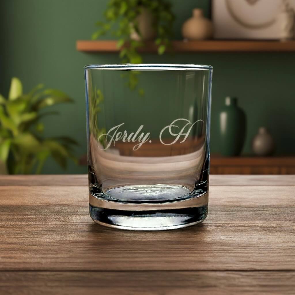 Clear side view of engraved whiskey glass showing "Jordy H" etched on the Side.