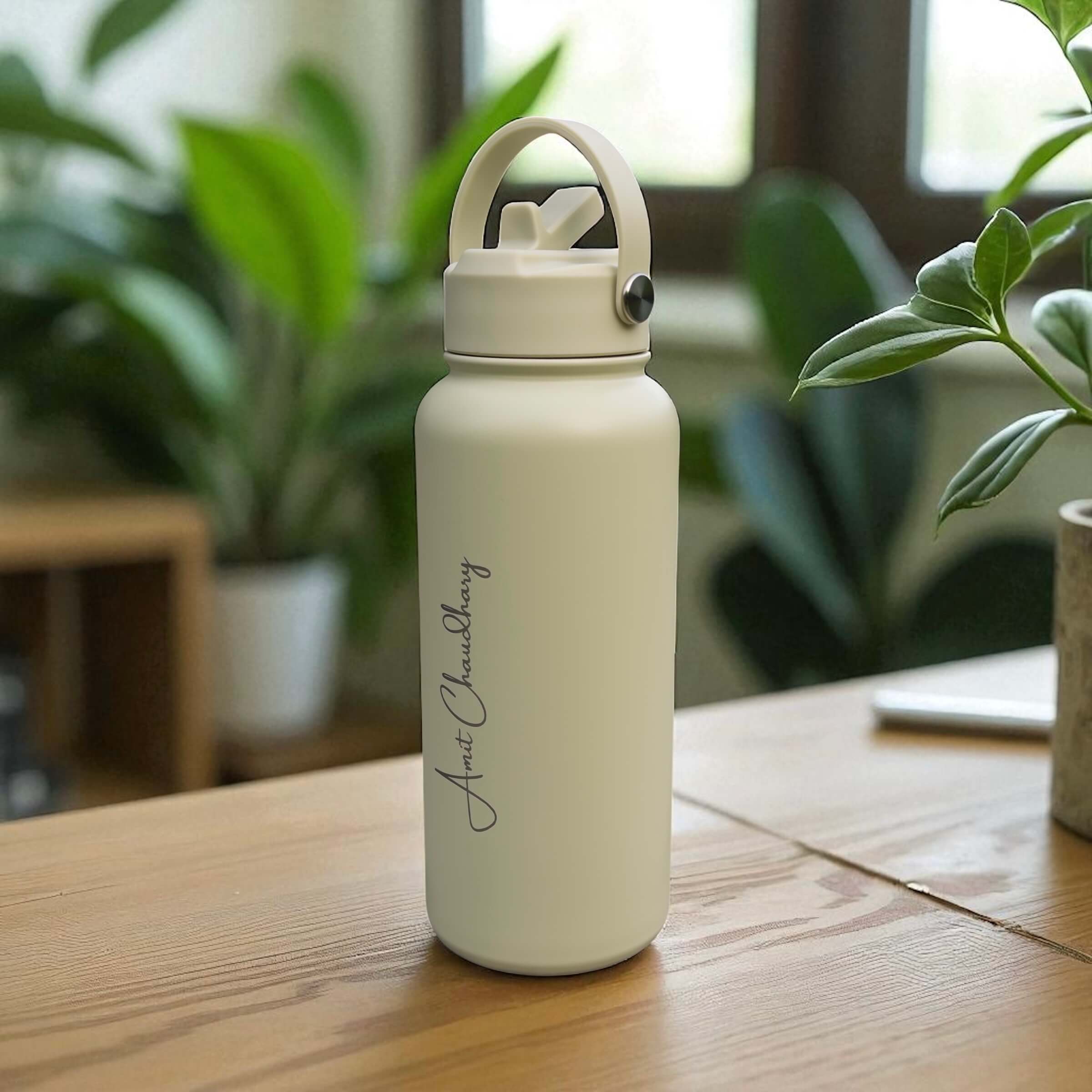 Close-up of engraved name on sage stainless steel water bottle, highlighting sleek powder coated finish.