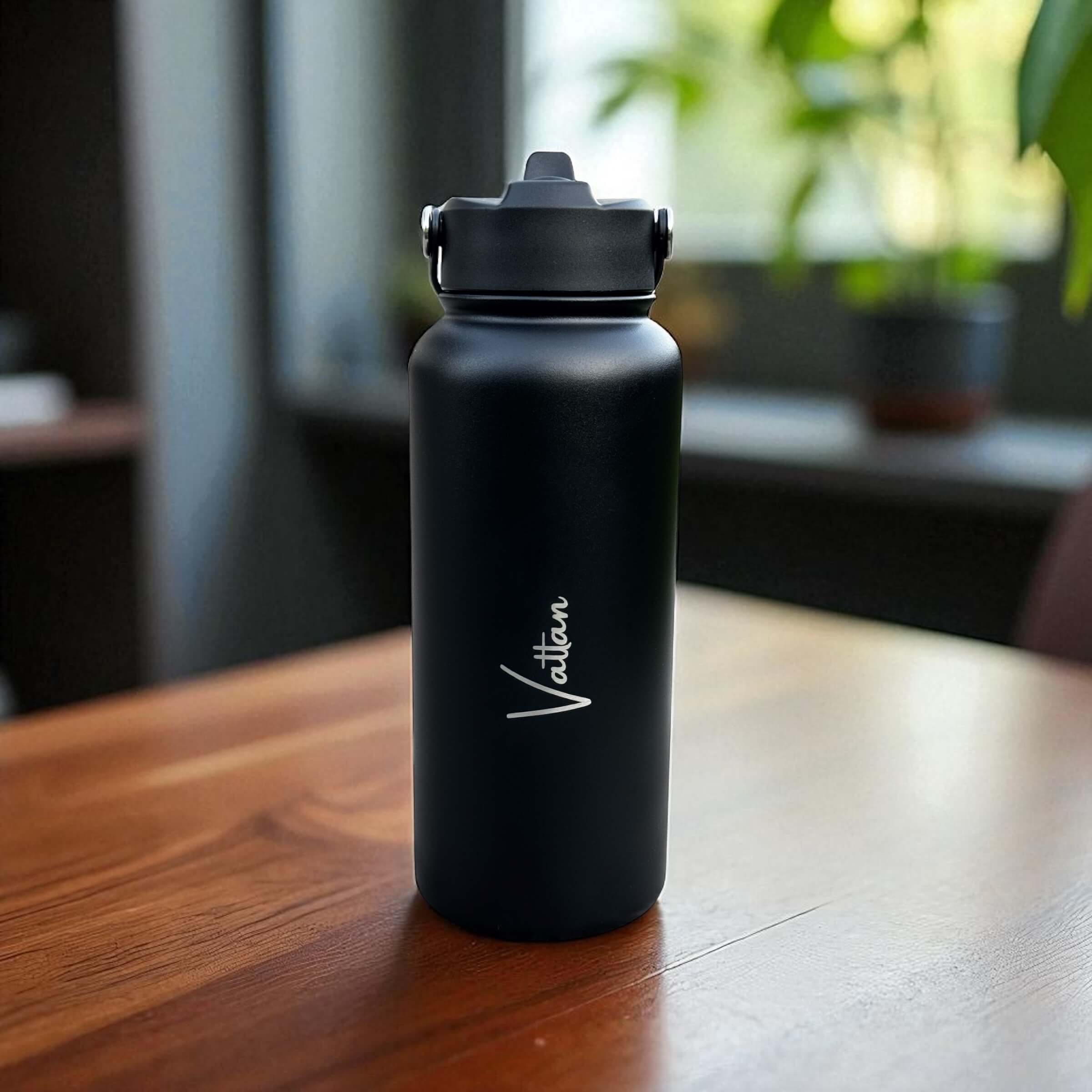 Close-up of personalised stainless steel water bottle highlighting engraved name and sleek design.