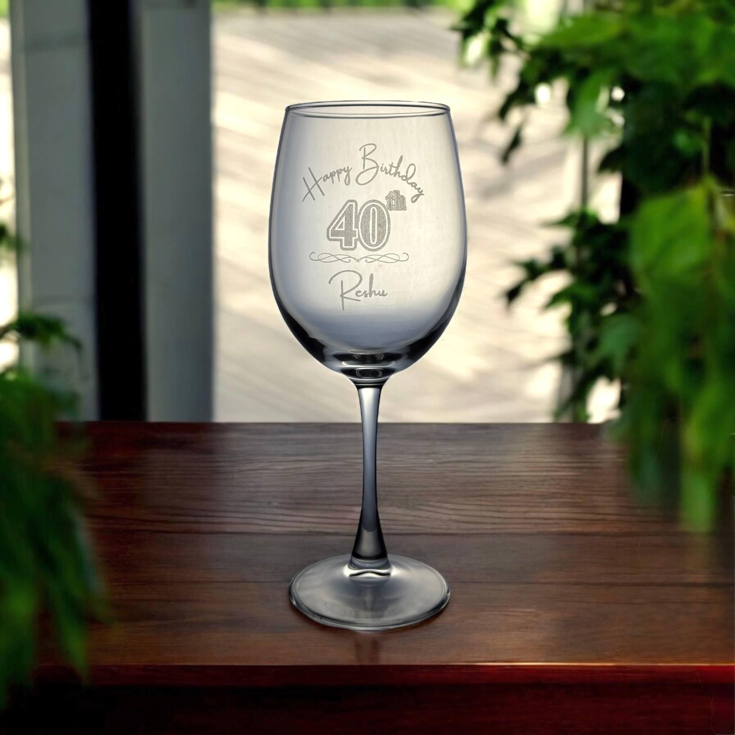 Personalised birthday wine glass with “Happy Birthday 40th Reshu” engraved in elegant script.