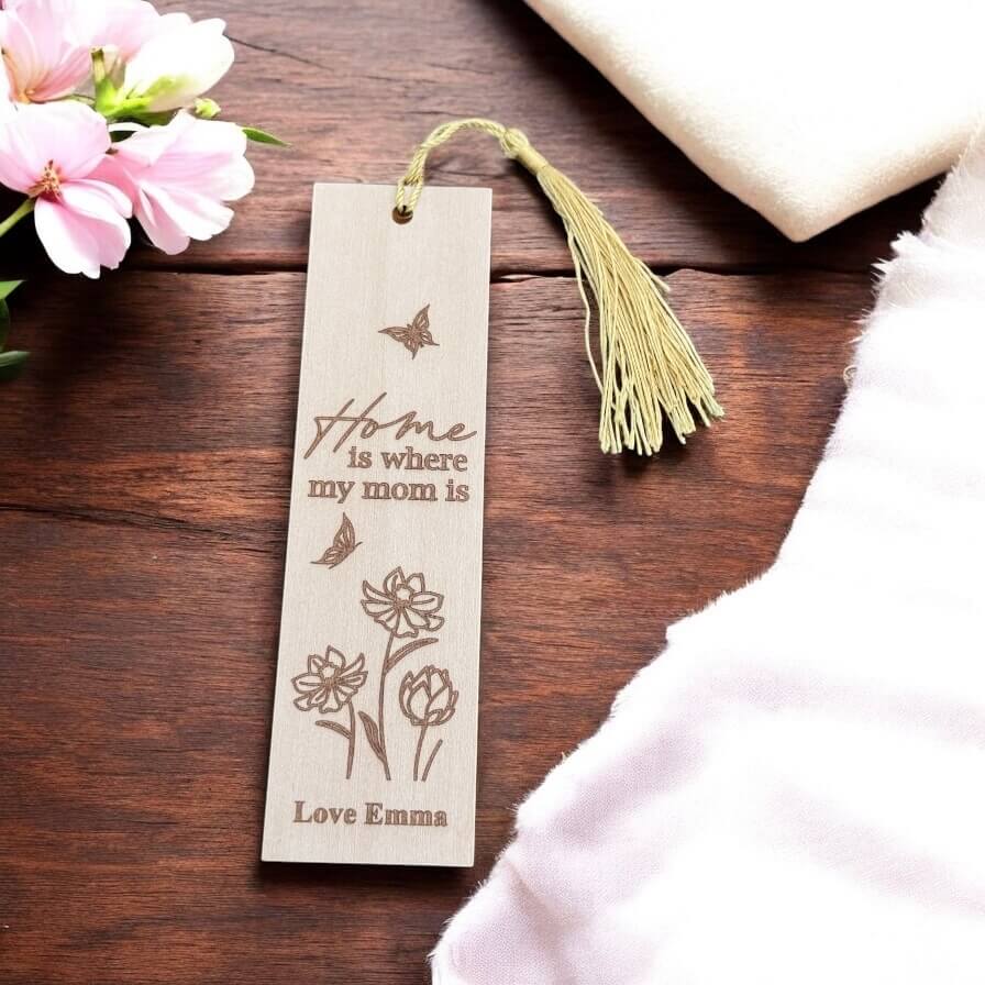 Flat lay of custom wooden bookmark with golden tassel on rustic wood table