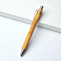 Angled personalised bamboo pen with custom teacher name engraving and polished metal details