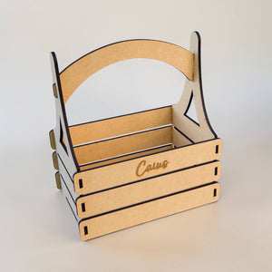 Angled view of personalised nursery gift basket with baby name on a white background