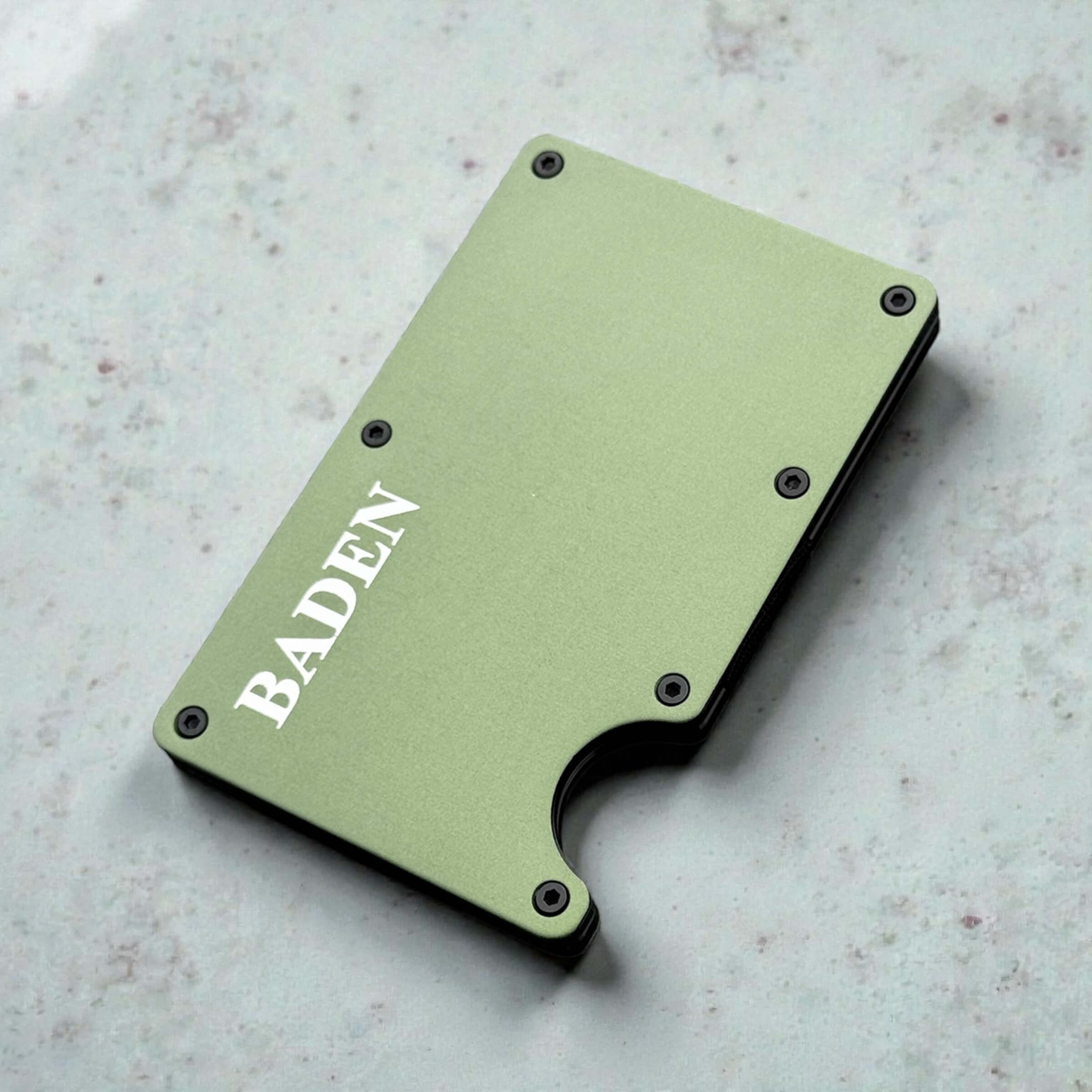 Angled view of personalised wallet with smooth metal finish and engraved lettering