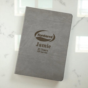 Angled view of professional grey A4 journal with engraved branding and personalisation, great for business events, client gifts, or employee milestones.