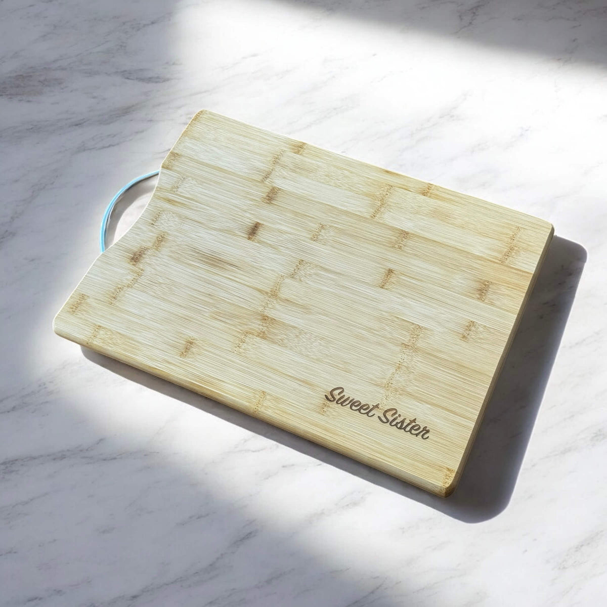 Bamboo board displayed on kitchen counter with natural light, engraved with custom message