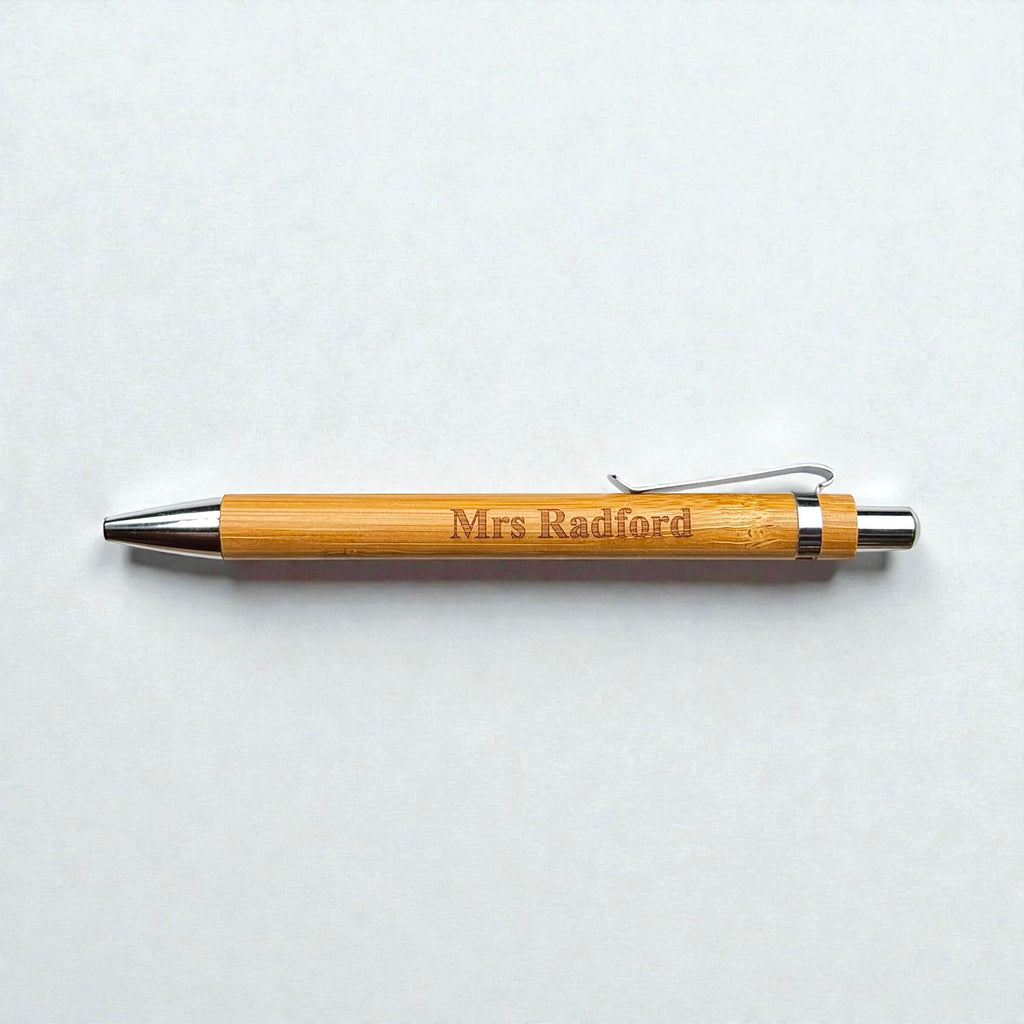 Bamboo pen with 'Mrs Radford' engraving on a light gray background