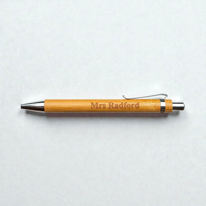 Bamboo pen with 'Mrs Radford' engraving on a light gray background