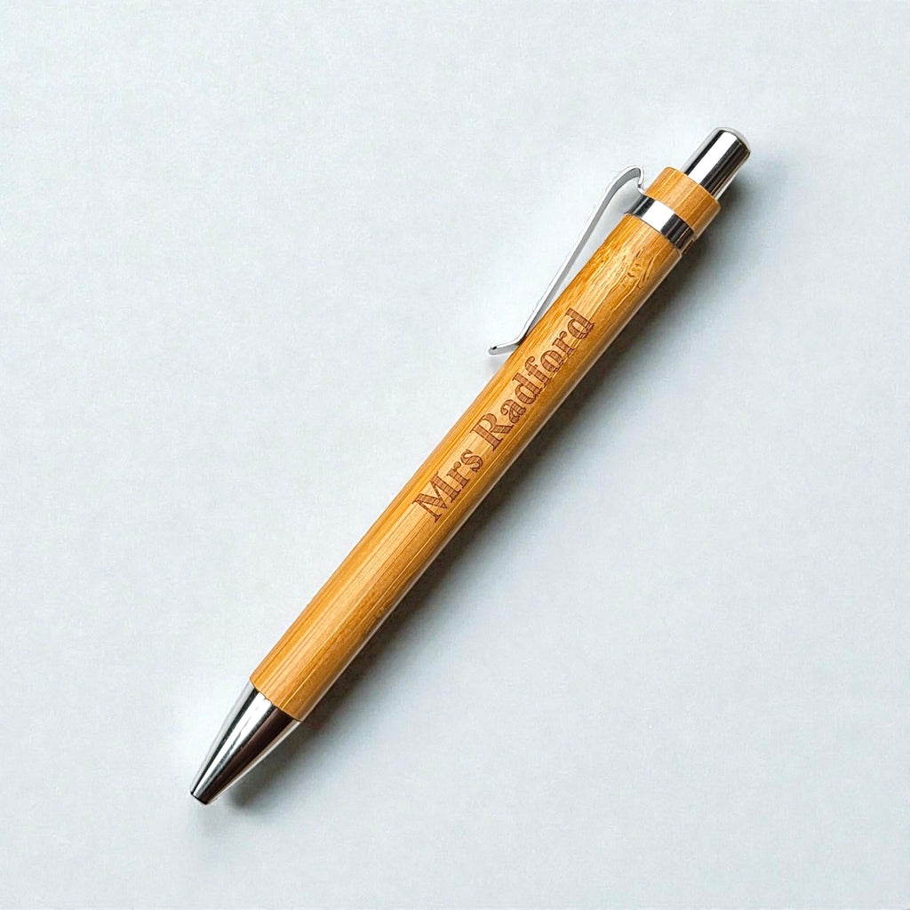 Bamboo teacher pen with Mrs Radford name engraving, silver clip and chrome tip on a white background