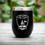 Black 300ml corporate coffee cup engraved with logo, styled on rustic wooden surface.