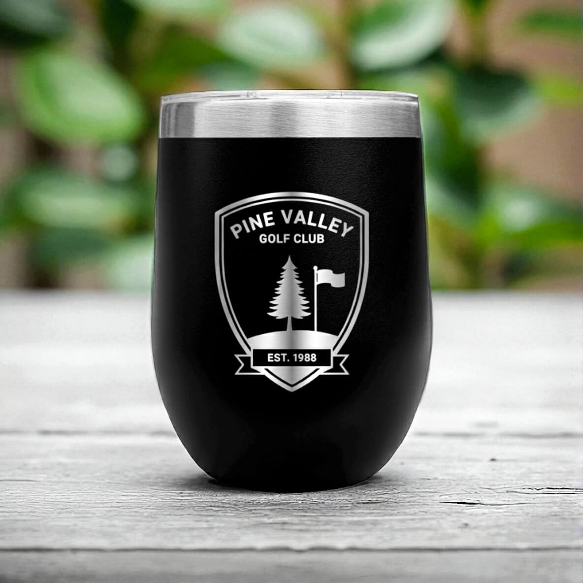 Black 300ml corporate coffee cup engraved with logo, styled on rustic wooden surface.