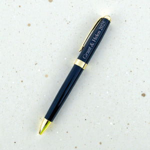 Black engraved anniversary pen with Grant and Helen 2025, gold accents, and a textured surface