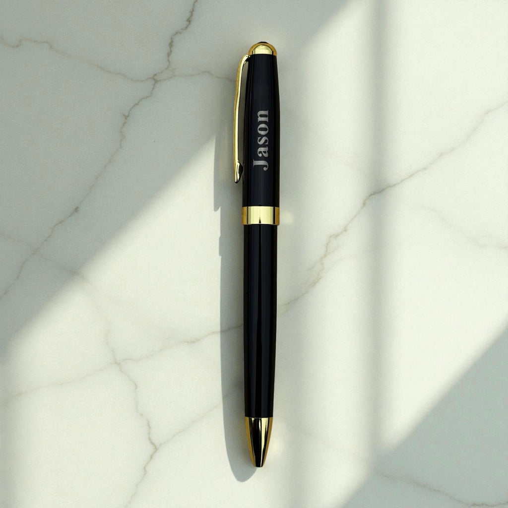 Black metal pen engraved with a name on marble surface