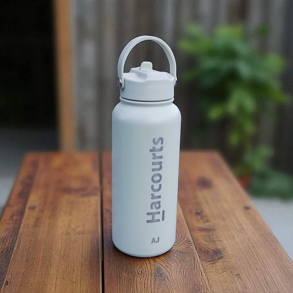 Branded 1L water bottle with straw lid shown in corporate setting.