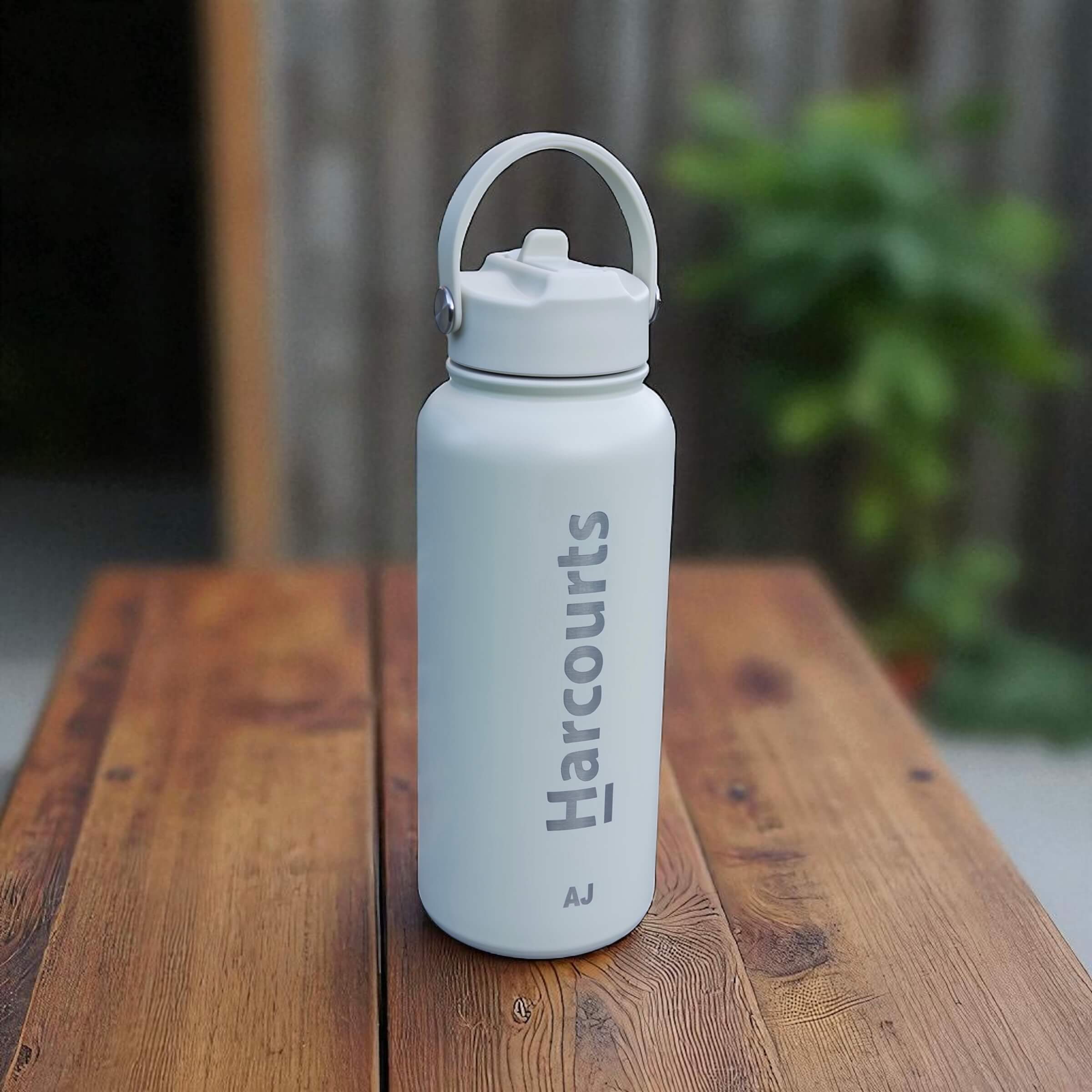 Branded 1L water bottle with straw lid shown in corporate setting.