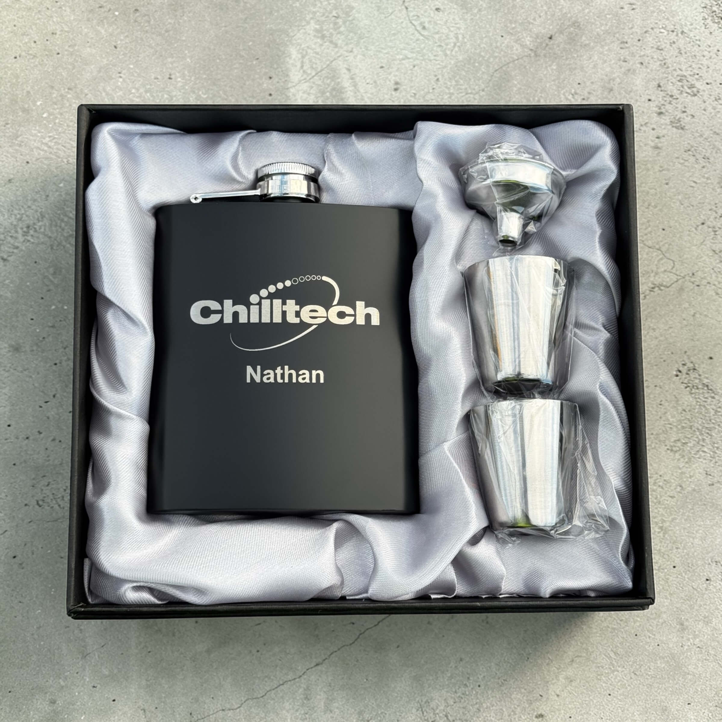 Branded black hip flask with engraved company logo and name in gift box with shot glasses and funnel, corporate gift set