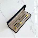 Branded engraved pen inside luxury gift box, photographed on marble background.