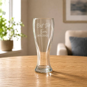 Clear 425ml beer glass with etched Dad message in a warm home setting