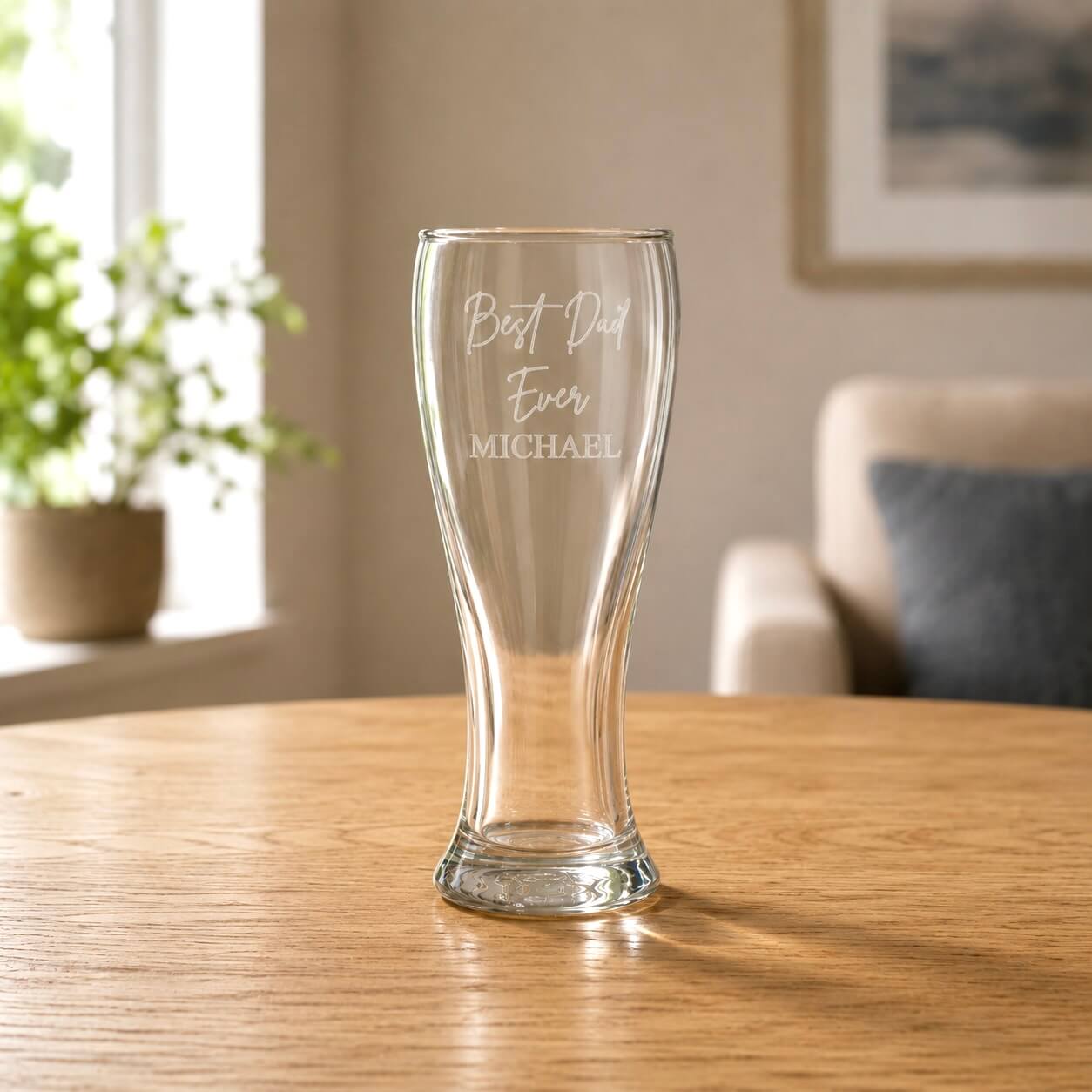 Clear 425ml beer glass with etched Dad message in a warm home setting