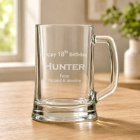 Clear beer handle with engraved Happy 18th Birthday Hunter message on wooden table