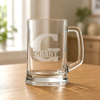 Clear beer mug with engraved Grant name and large G initial on wooden table
