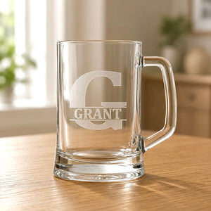 Clear beer mug with engraved Grant name and large G initial on wooden table