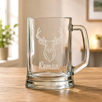Clear beer mug with engraved stag head and Roman name on wooden table