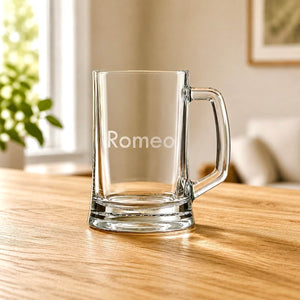 Clear beer mug with etched Romeo name, glass handle and wooden table setting