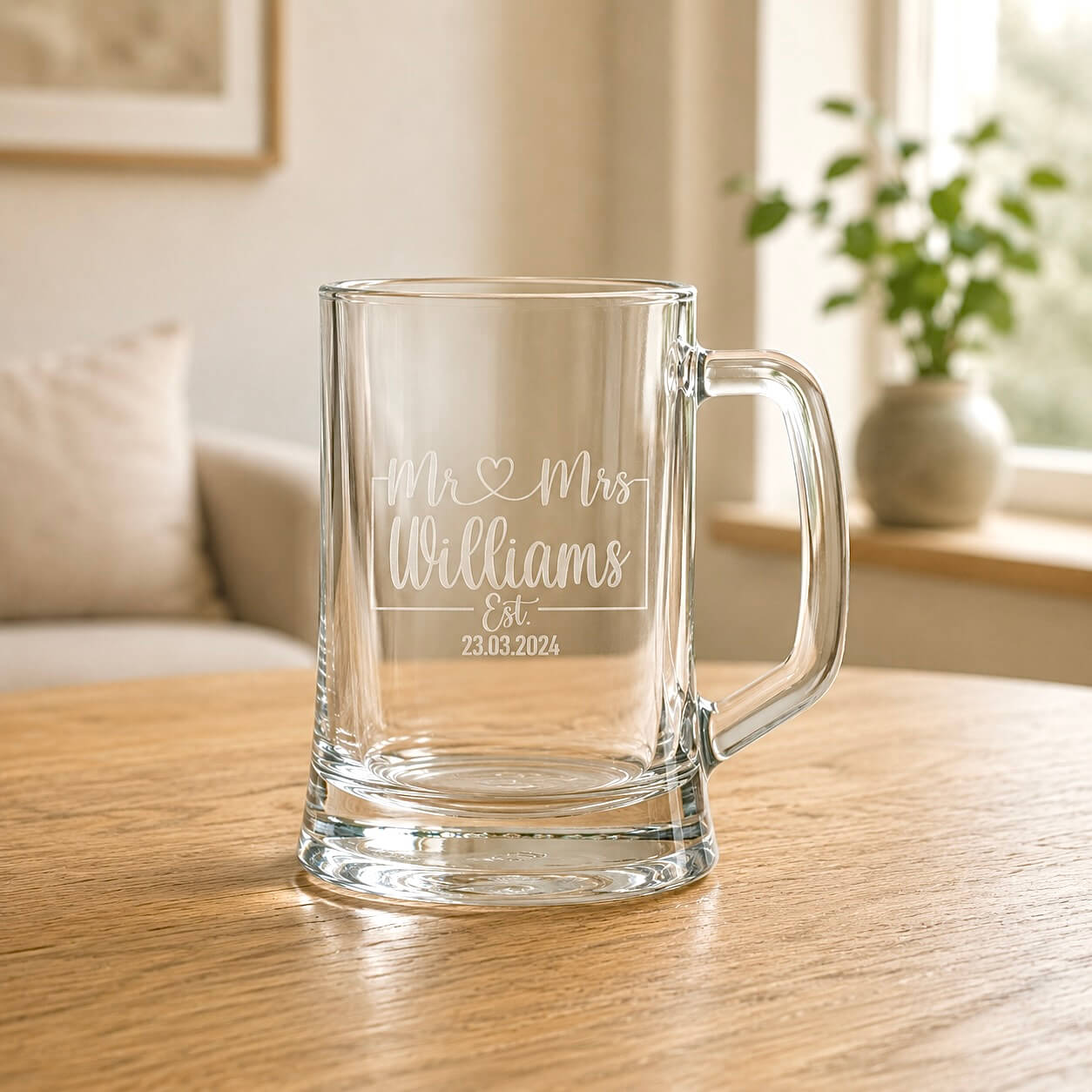 Clear glass beer mug with etched Mr and Mrs design in a warm home setting