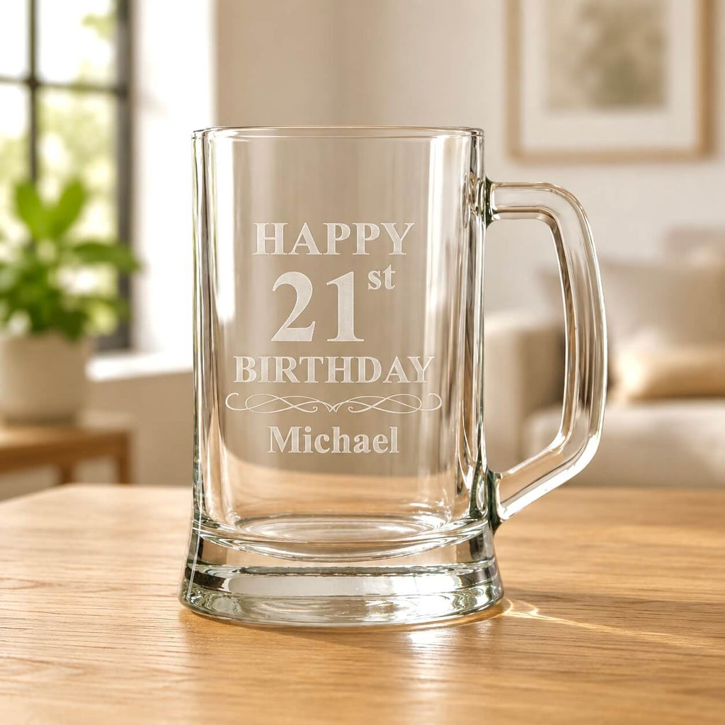 Clear glass beer stein etched “Happy 21st Birthday Michael” on a wooden table in a bright living room