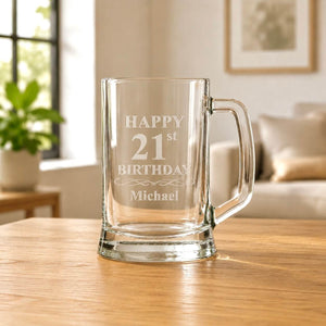 Clear glass beer stein with etched birthday message and name Michael, photographed on a wooden tabletop