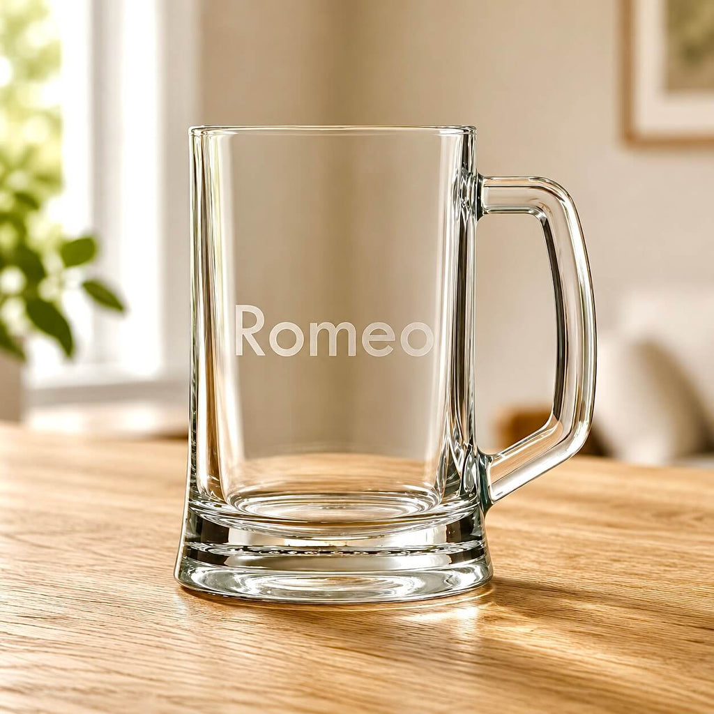 Clear glass beer tankard with engraved Romeo name on wooden table