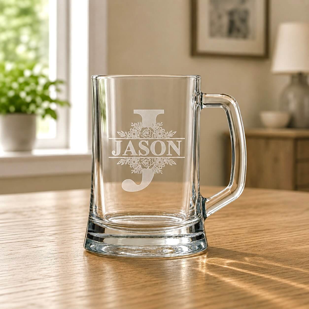Clear glass mug with 'JASON' engraving on a wooden table
