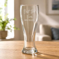 Clear pilsner beer glass with engraved Best Dad Ever Michael message on wooden table