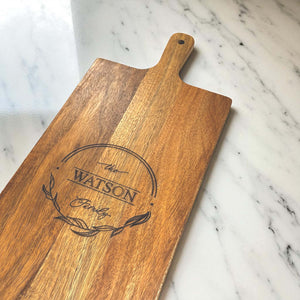 Close-up of custom wooden serving board with The Watson Family engraving