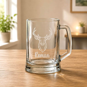Close-up of engraved beer glass with stag head, Roman name and thick clear base
