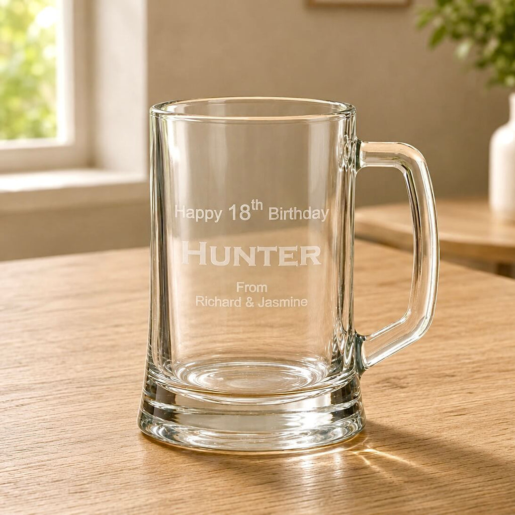 Close-up of engraved beer handle with Hunter 18th birthday design and clear glass base