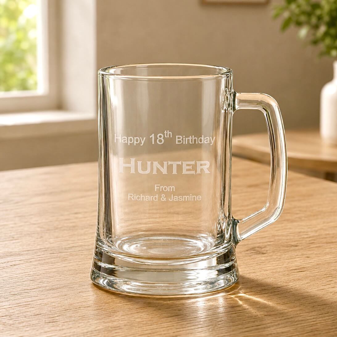 Close-up of engraved beer handle with Hunter 18th birthday design and clear glass base