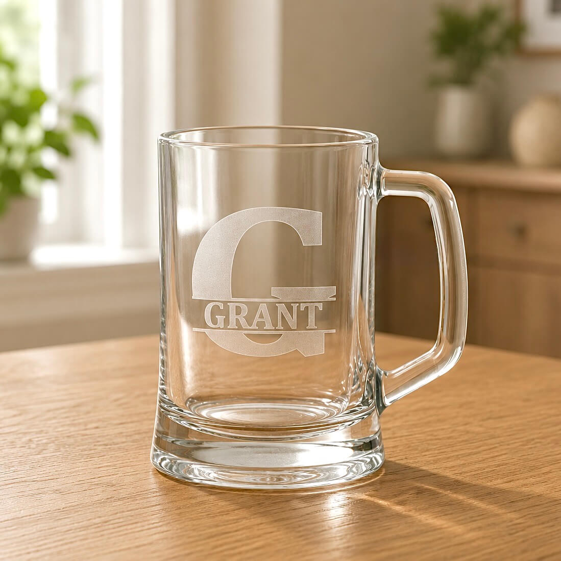 Close-up of engraved beer mug with Grant name, split G initial and warm home background