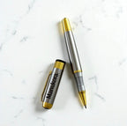 Close-up of engraved cap and open pen, highlighting logo detail and premium finish.