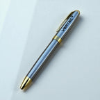 Close-up of engraved metal business pen showing custom logo detail
