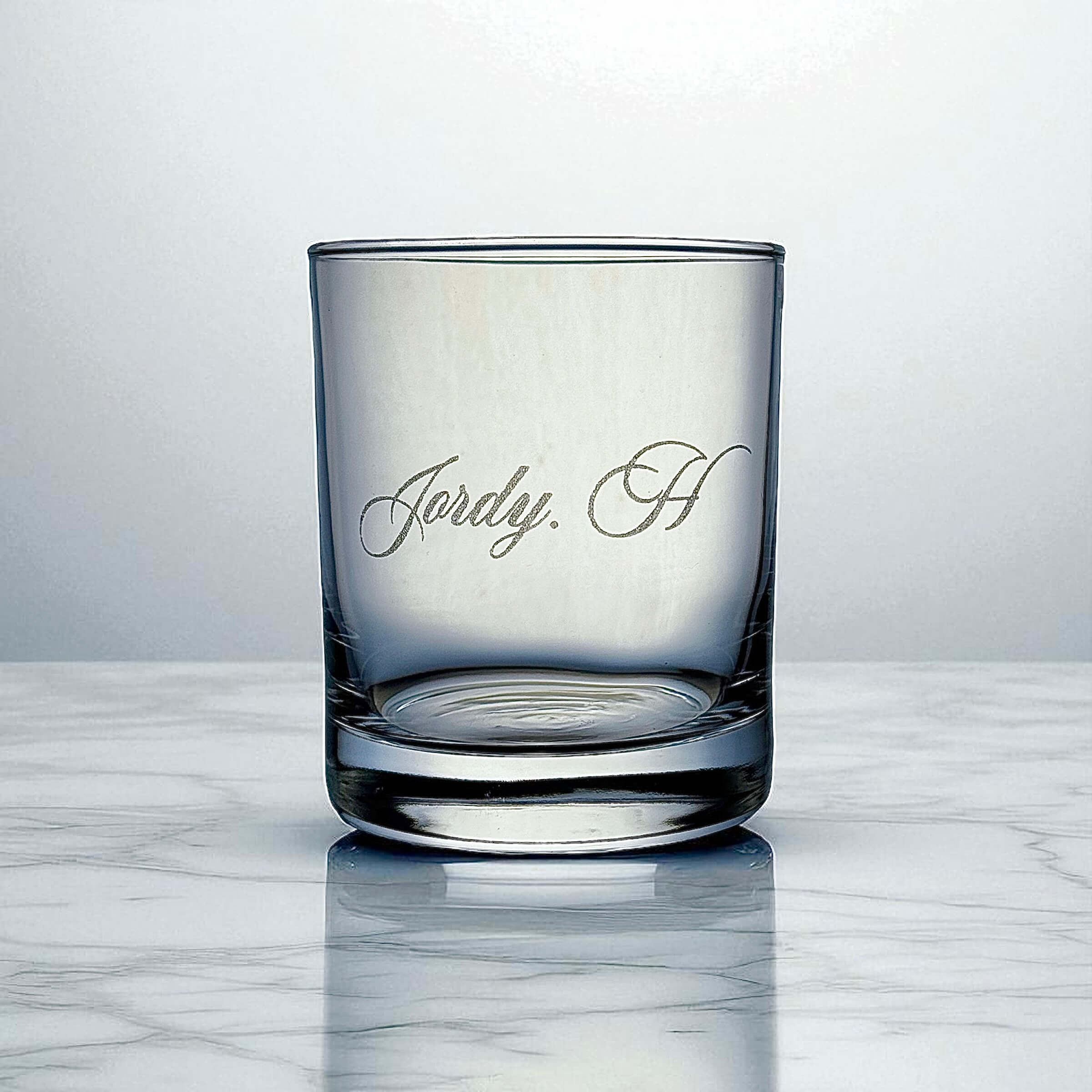 Close-up of engraved name detail on custom whiskey glass