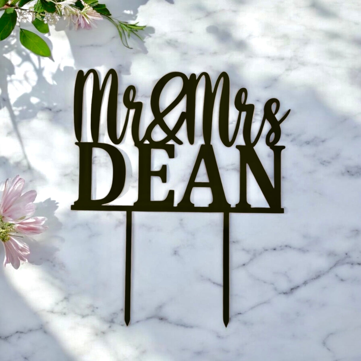 Close-up of laser-cut Mr & Mrs cake topper for a wedding cake