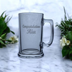 Close-up of laser engraving detail on graduation beer glass showing permanent frost-white finish