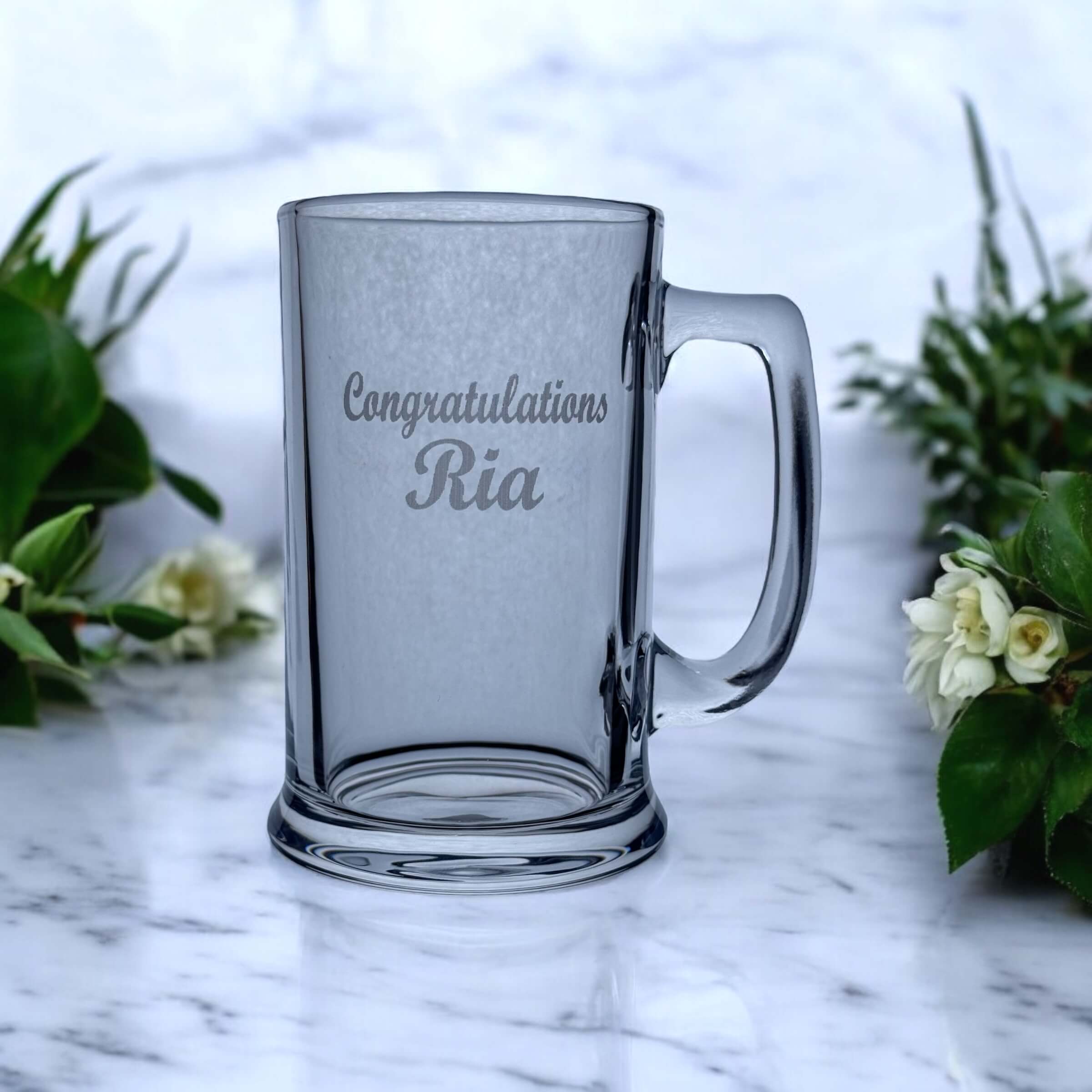Close-up of laser engraving detail on graduation beer glass showing permanent frost-white finish