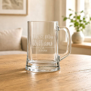 Close-up of personalised beer glass with frosted Mr heart Mrs design and Williams surname