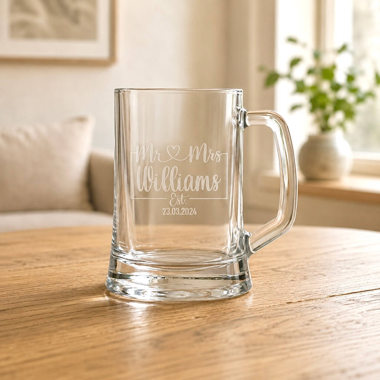 Close-up of personalised beer glass with frosted Mr heart Mrs design and Williams surname