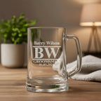 Close-up of personalised groomsmen beer handle with engraved initials BW and wedding date, elegant keepsake gift