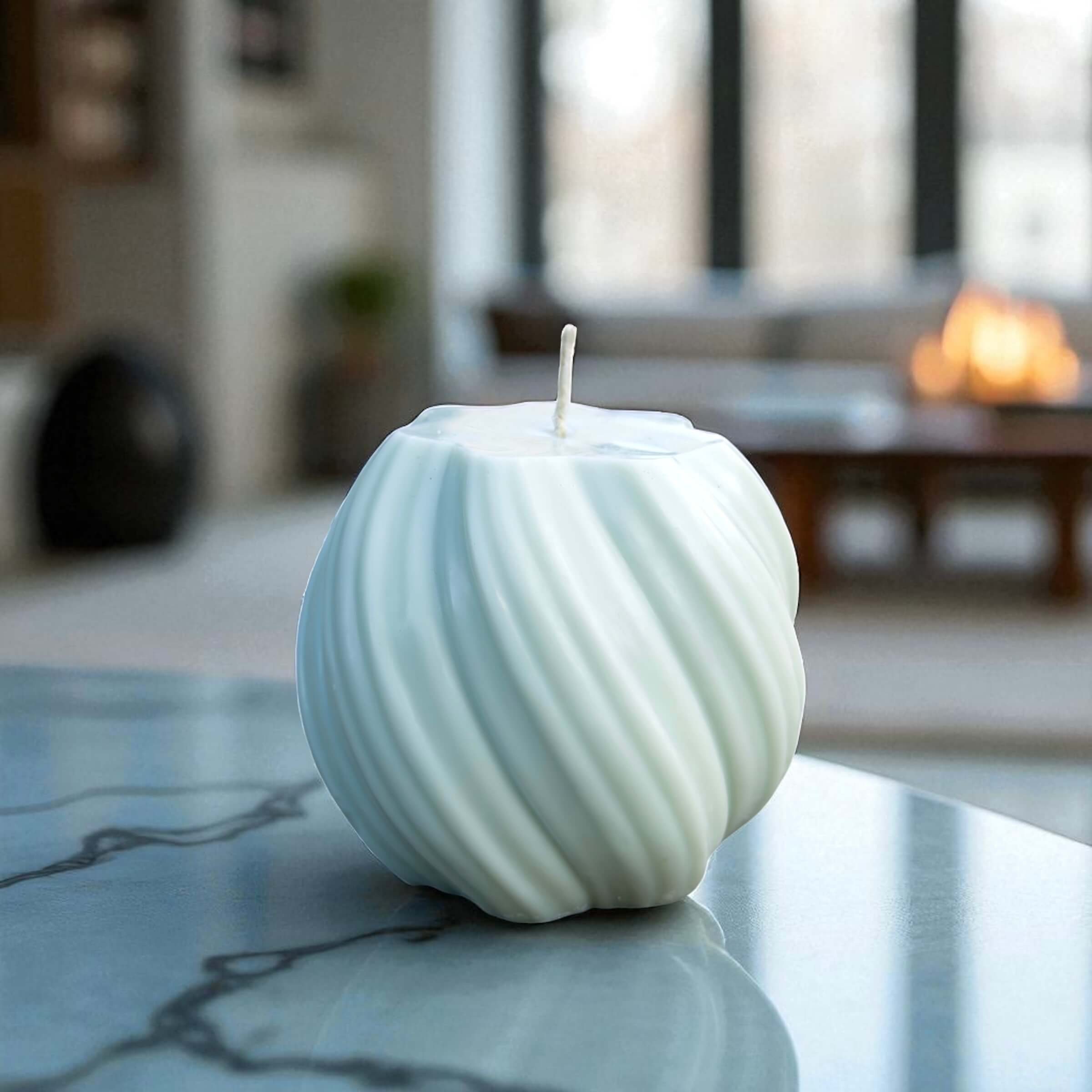 Contemporary sculptural candle featuring elegant swirl lines, ideal for home decor or gifting.