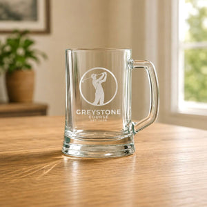 Corporate gift beer mug with etched golf club logo in warm home setting